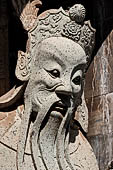 Bangkok Wat Arun - Details of the statues of Chinese saints of the pagoda at the corners of the Ubosot coutyard. 